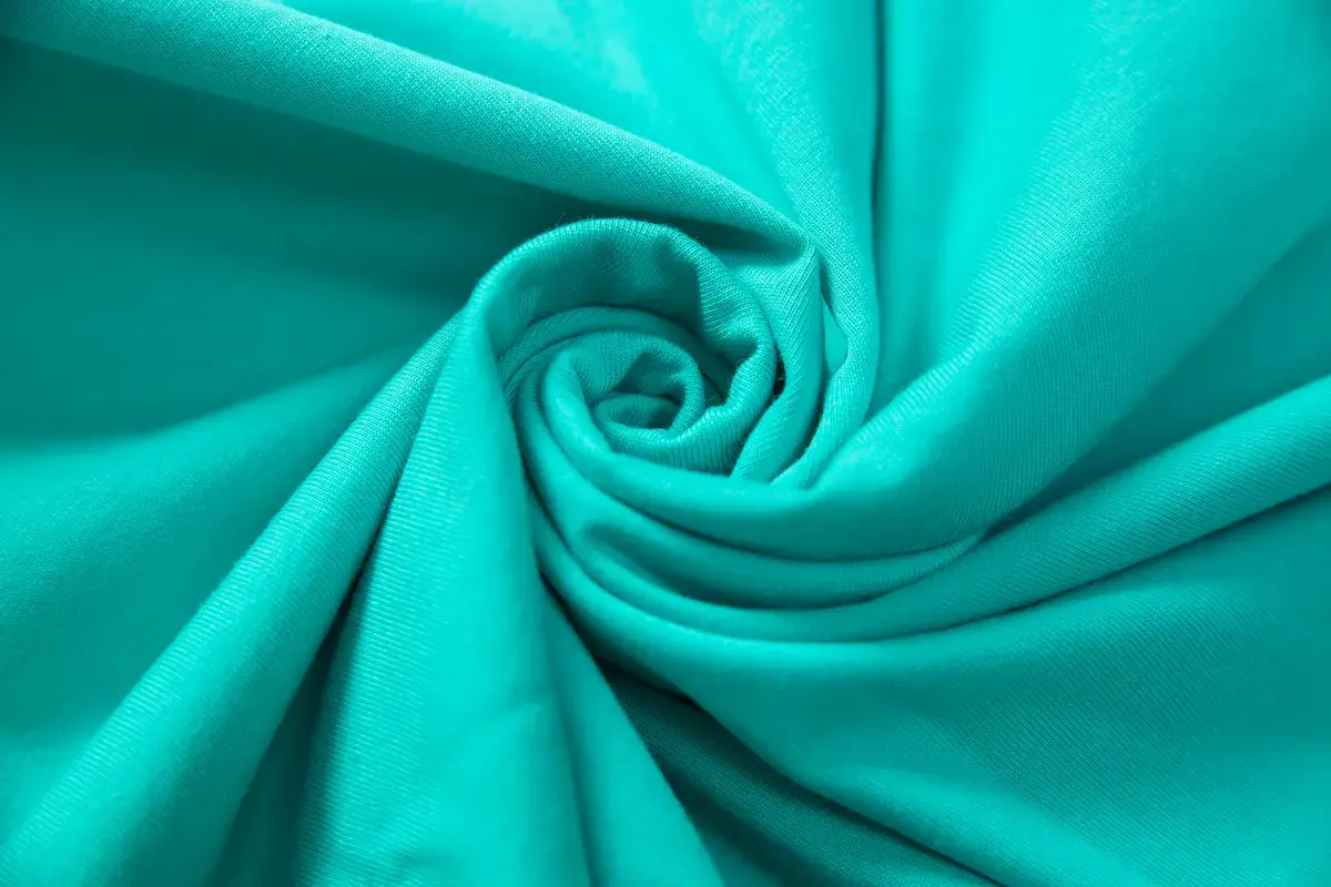 ARRIVE GUIDE AG21000 重磅精梳棉 T 恤近距離細節圖，展示 210 克高密度布料的細膩織紋與領口處工整的加強縫線。